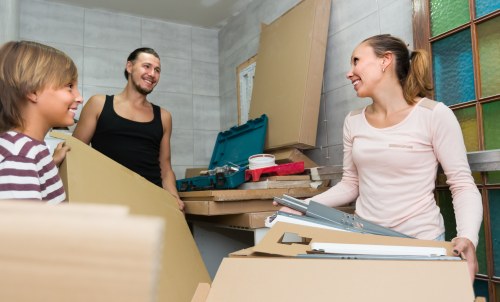 Removal van and packed household boxes in a Bow street setting