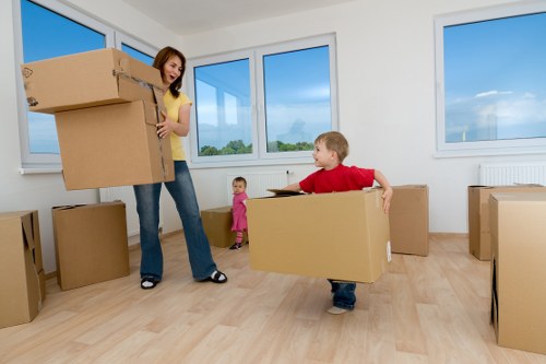 House moving team loading boxes and wrapped furniture into a van