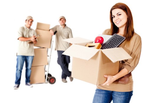 Packed moving boxes and furniture ready for collection in Bow