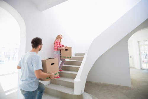 Packed moving boxes and furniture ready for removals in Bow