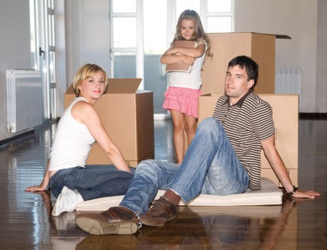 Local removals crew handling household items in East London